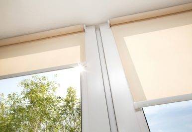 Sun streaming through windows that are partially covered by motorized shades.