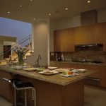 A kitchen with recessed ambient lights, task lighting, and accent lighting.